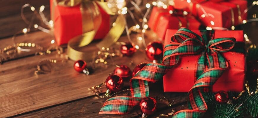 Gift,Boxes,With,A,Large,Red,Bow,Against,A,Background